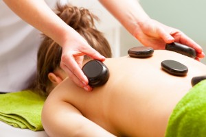 hot stones on a massage therapy customer